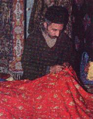 Embroidering a shawl with Kashmiri motifs.