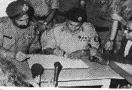 Gen. A. A. Niazi of Pakistan surrenders to Gen. J. S. Aurora of India, after the liberation of Bangladesh.